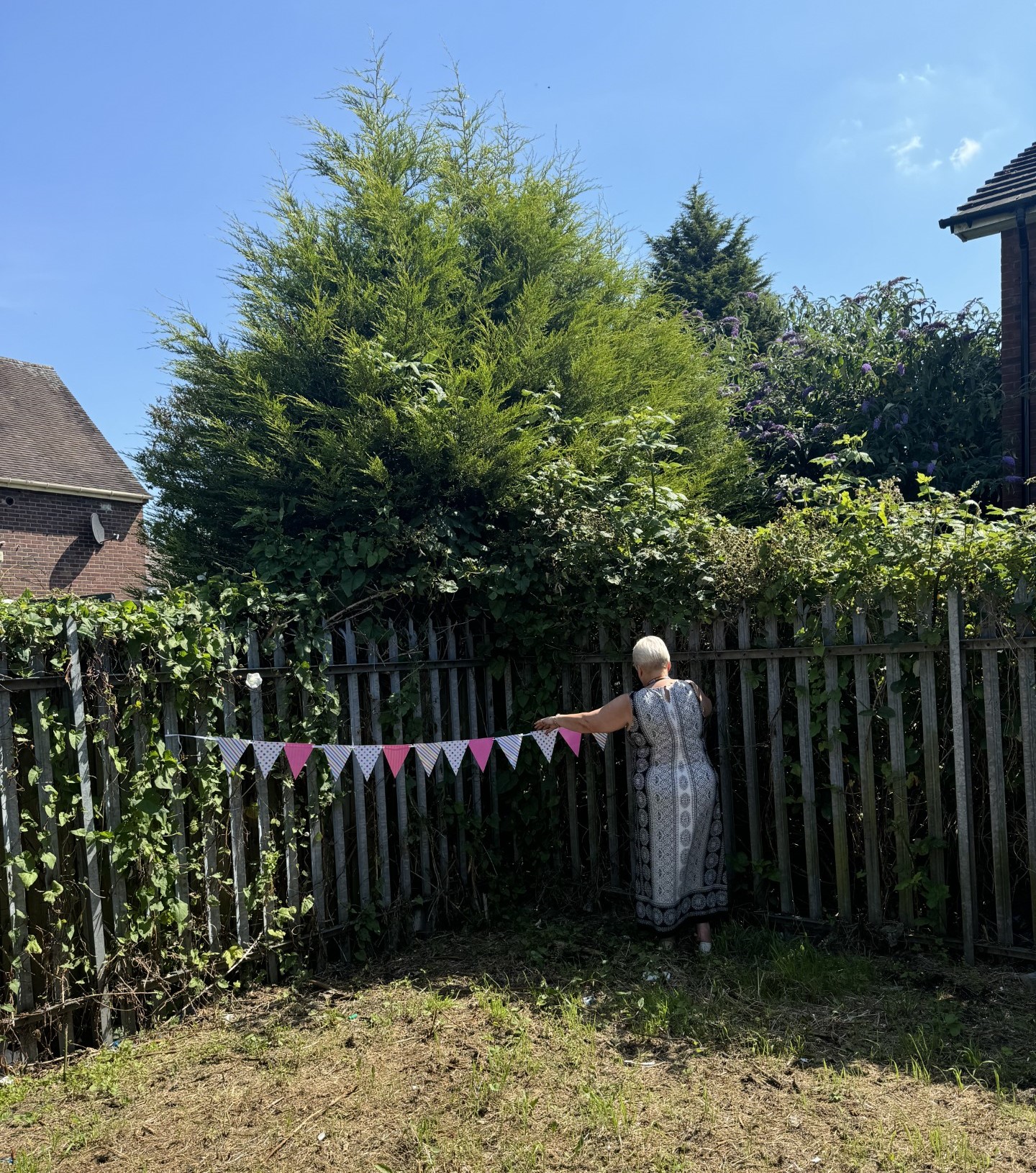 A woman hanging some bunting flags